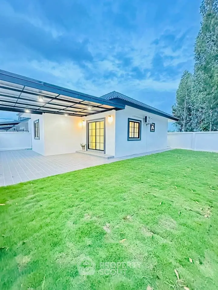 Charming single-story home with lush green lawn and modern exterior design.