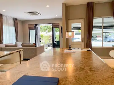 Spacious living room with elegant decor and large windows offering natural light.