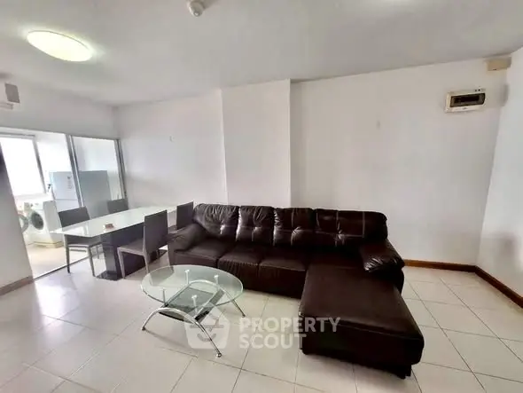 Spacious living room with modern leather sofa and glass coffee table