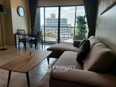 Spacious living room with modern furniture and city view balcony
