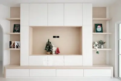 Modern living room with built-in shelving and festive decor