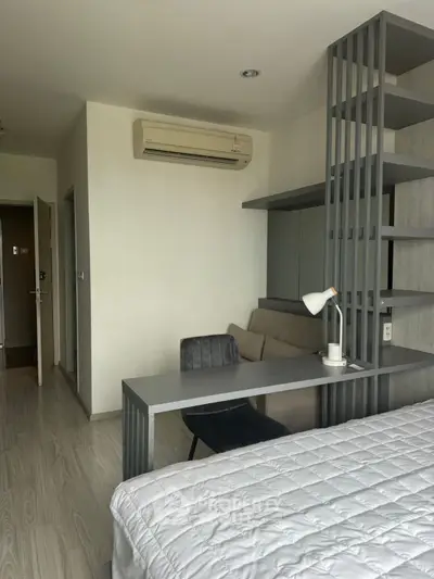 Modern bedroom with stylish desk and air conditioning in a cozy apartment.