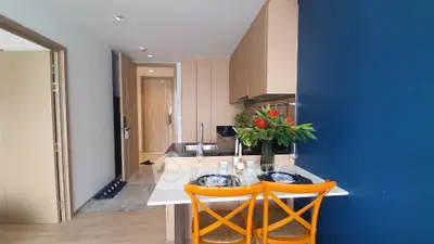 Modern kitchen with open layout and stylish dining area in contemporary apartment