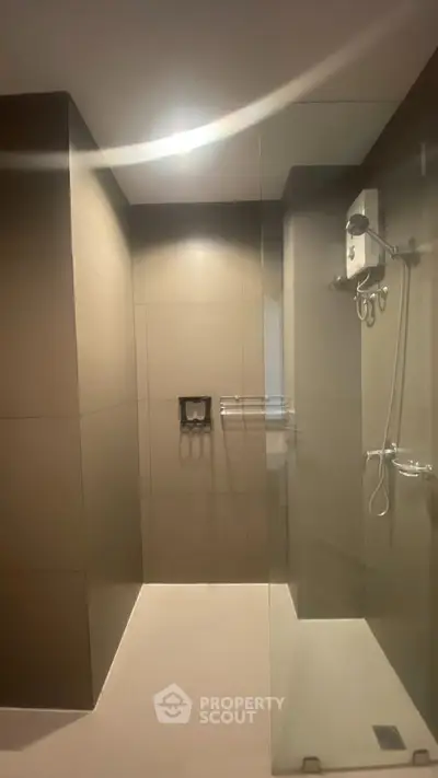 Modern bathroom with sleek glass shower and minimalist design.