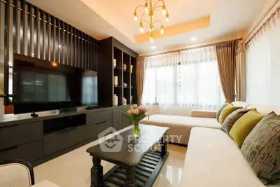 Elegant living room with modern decor, large TV, and cozy seating area, perfect for relaxation and entertainment.