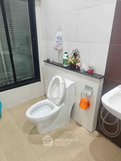 Modern bathroom with sleek design and large window for natural light.