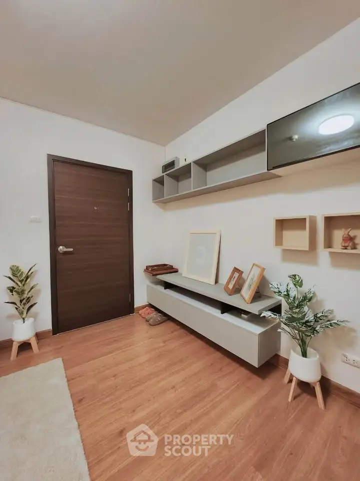 Modern living room with wooden flooring and stylish shelving