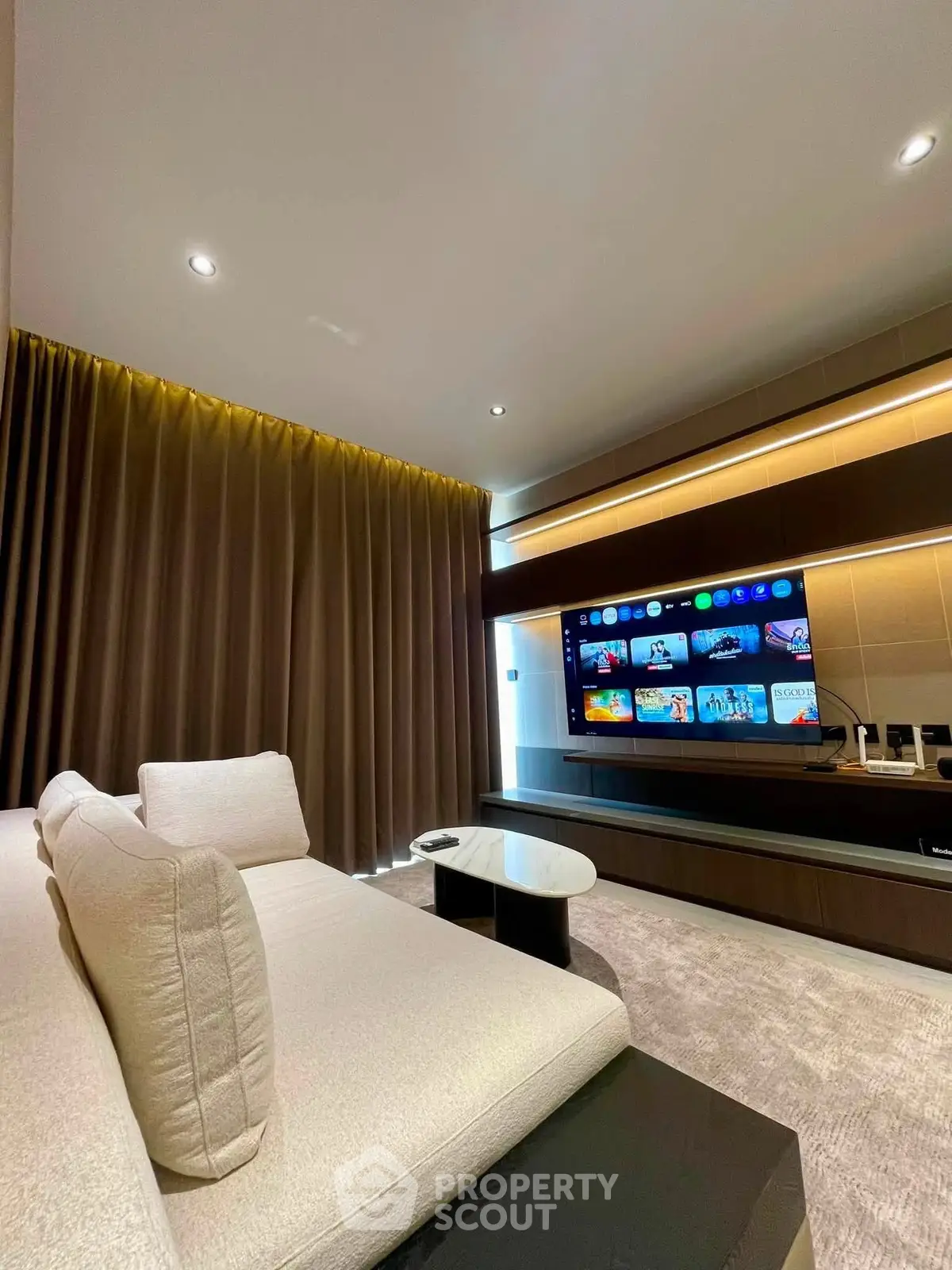 Luxurious living room with modern entertainment setup and plush seating