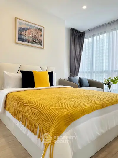Modern bedroom with vibrant yellow accents and large window view.