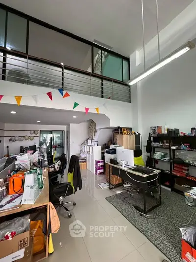 Spacious modern office space with mezzanine and open layout, ideal for creative work environments.