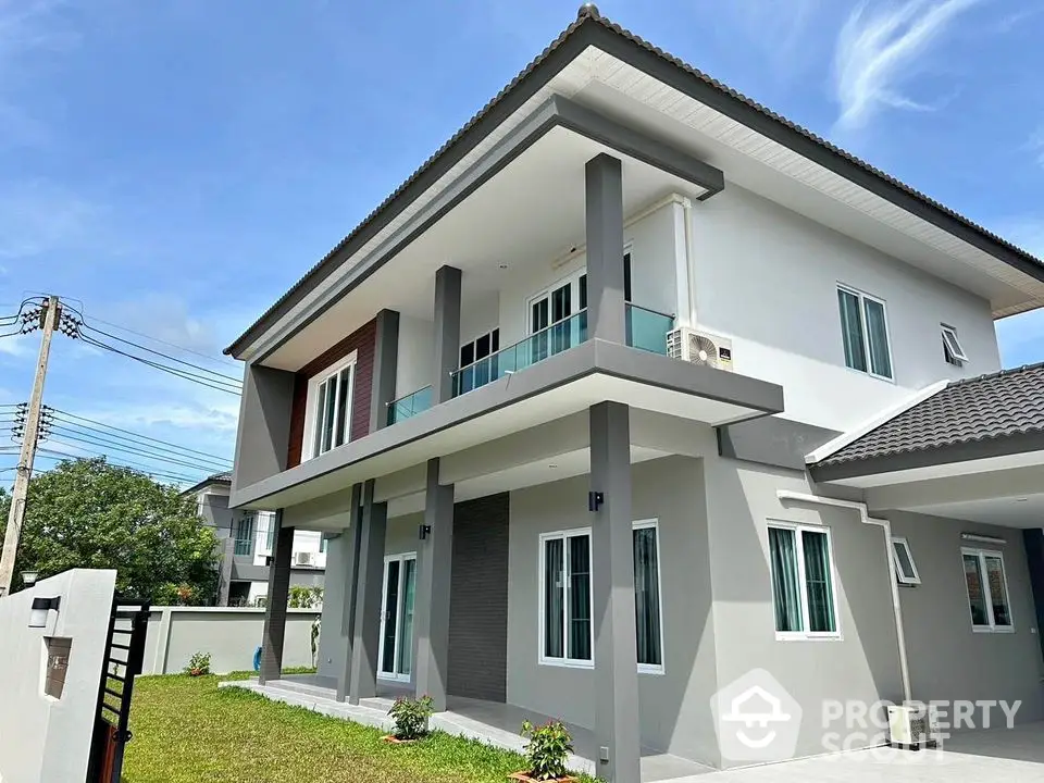 Modern two-story house with sleek design and spacious balcony in a serene neighborhood.