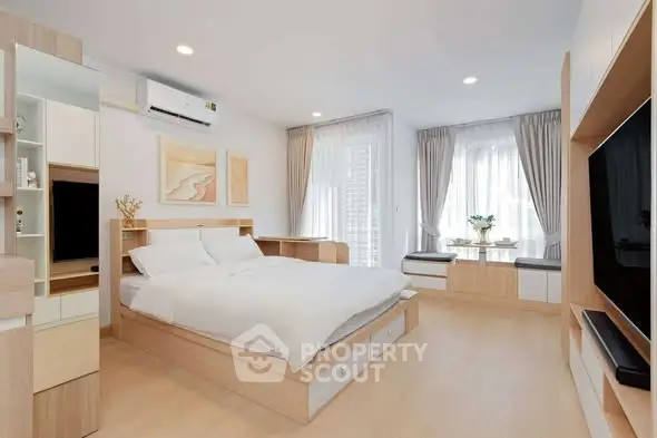 Modern bedroom with stylish decor and natural light