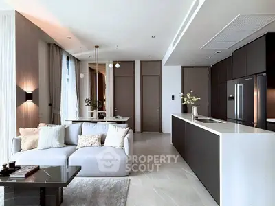 Luxurious open-plan living room and kitchen with modern decor and sleek finishes.
