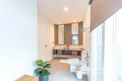 Spacious modern bathroom with dual sinks and natural light