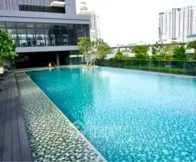 Luxurious rooftop pool with city skyline view in modern apartment complex.