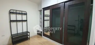 Spacious bedroom with large mirrored wardrobe and modern coat rack