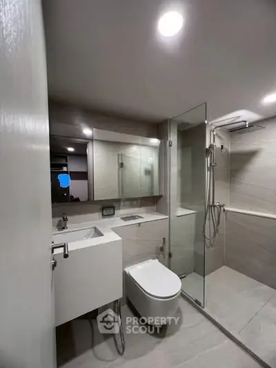Modern bathroom with sleek fixtures and glass shower enclosure