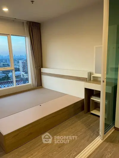 Modern bedroom with city view and wooden flooring in high-rise apartment