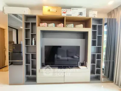 Modern living room with sleek entertainment center and large TV