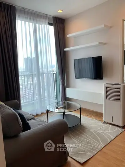 Modern living room with city view, cozy sofa, and wall-mounted TV in a stylish apartment.