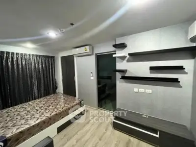 Modern bedroom with sleek design, featuring built-in shelves and stylish flooring.