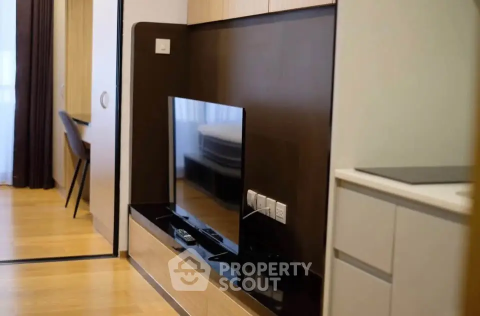 Modern living room with sleek TV setup and stylish wooden flooring
