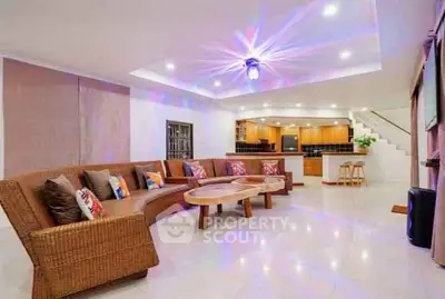 Spacious living room with modern decor and open kitchen layout