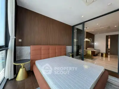 Luxurious bedroom with modern design and large windows offering natural light