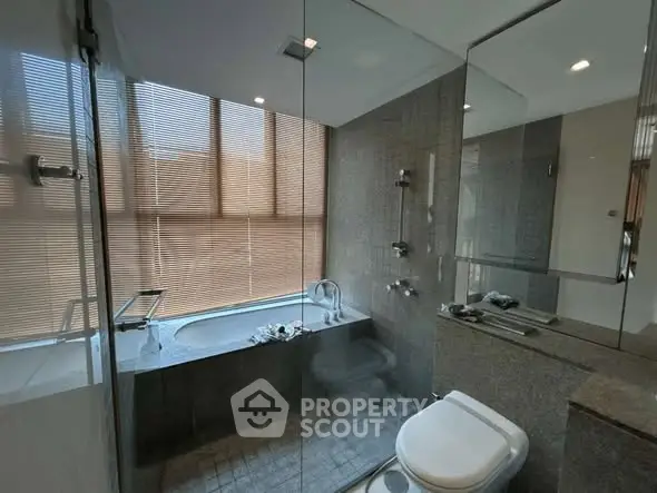 Luxurious modern bathroom with glass shower and elegant bathtub