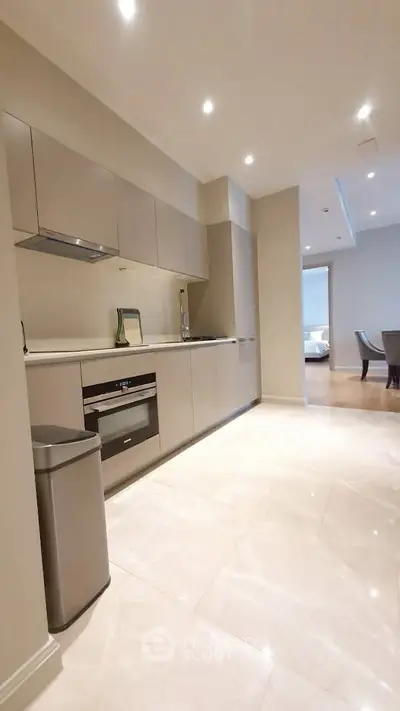 Modern kitchen with sleek cabinetry and integrated appliances in a luxurious apartment.