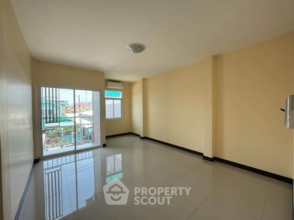 Spacious unfurnished room with large windows and tiled flooring