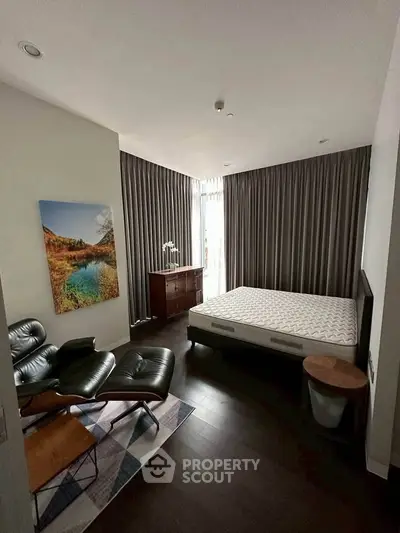 Modern bedroom with stylish furniture and large window for natural light.