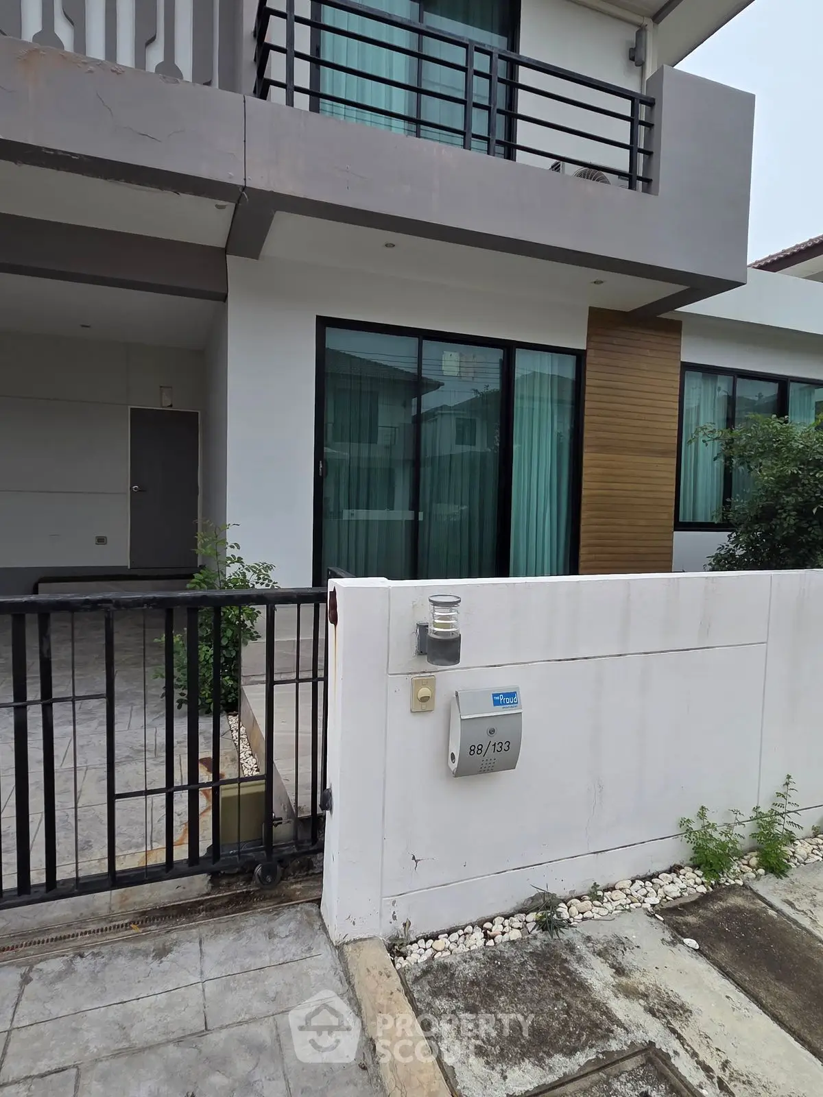 Modern townhouse exterior with sleek design and gated entrance