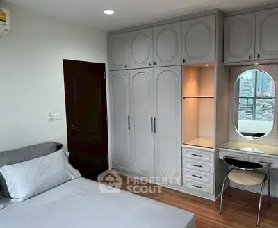Spacious bedroom with built-in wardrobe and city view