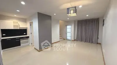 Modern open-plan living area with sleek kitchen and stylish lighting