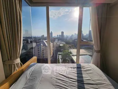 Stunning bedroom with panoramic city view from floor-to-ceiling windows, perfect urban retreat.