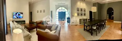Spacious open-plan living and dining area with elegant decor and natural light.
