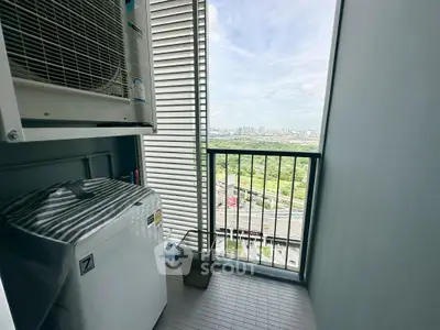 High-rise balcony with city view and washing machine setup