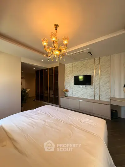 Luxurious bedroom with elegant chandelier and modern decor