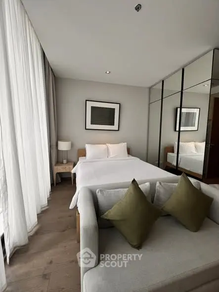 Elegant bedroom with floor-to-ceiling windows and modern decor