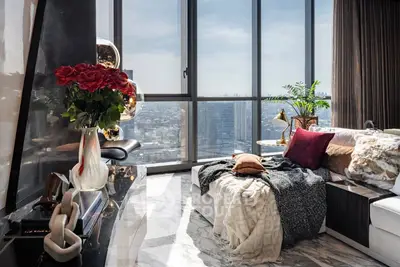 Luxurious living room with panoramic city view and elegant decor.