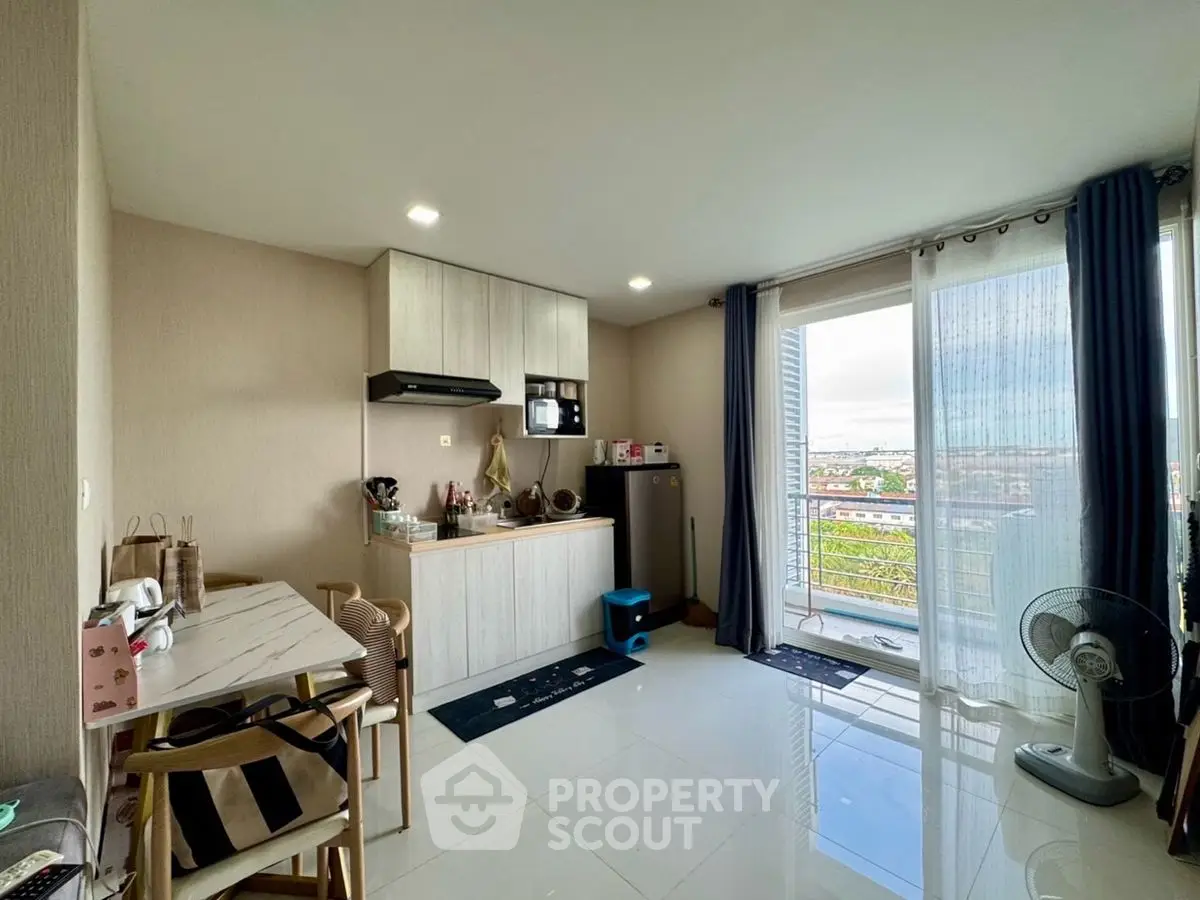 Modern kitchen with open layout and balcony view in stylish apartment