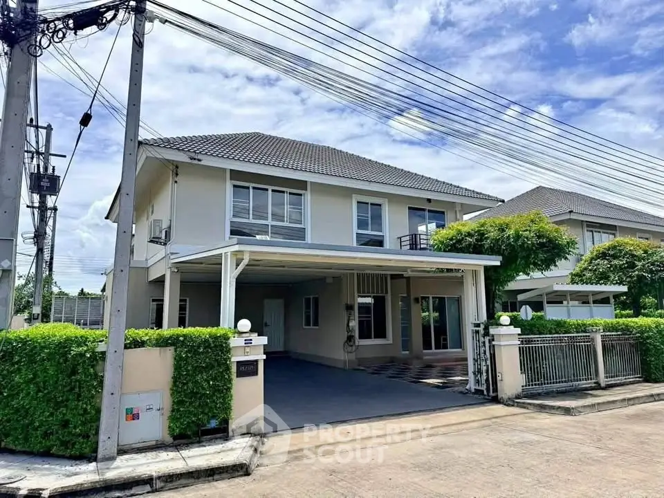 Spacious two-story house with modern design and lush greenery in a serene neighborhood.