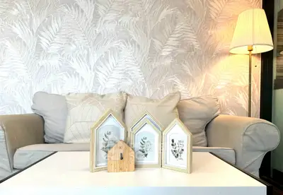 Stylish living room with cozy sofa, elegant lamp, and decorative accents on coffee table.