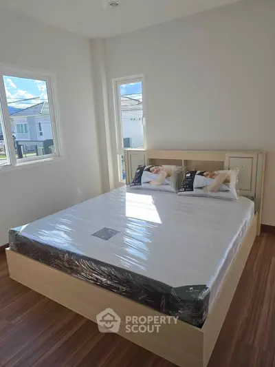 Bright and airy bedroom with large windows and modern decor in a stylish home.