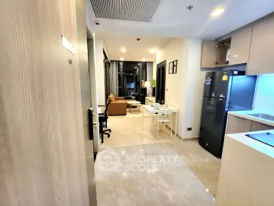Modern open-layout apartment with sleek kitchen and cozy living area, perfect for urban living.
