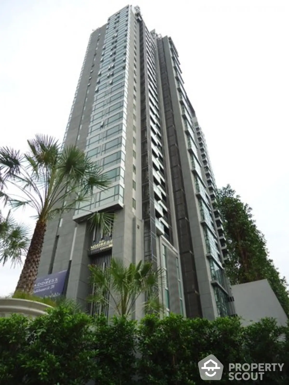 Stunning high-rise building with modern architecture and lush greenery