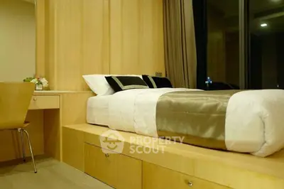 Modern bedroom with sleek wooden design and large window, offering a cozy and elegant ambiance.