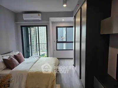 Modern bedroom with large window and stylish decor in urban apartment
