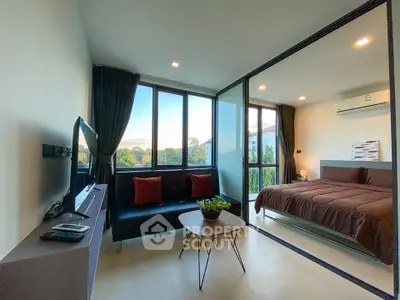 Modern bedroom with large windows and cozy seating area, featuring stylish decor and natural light.